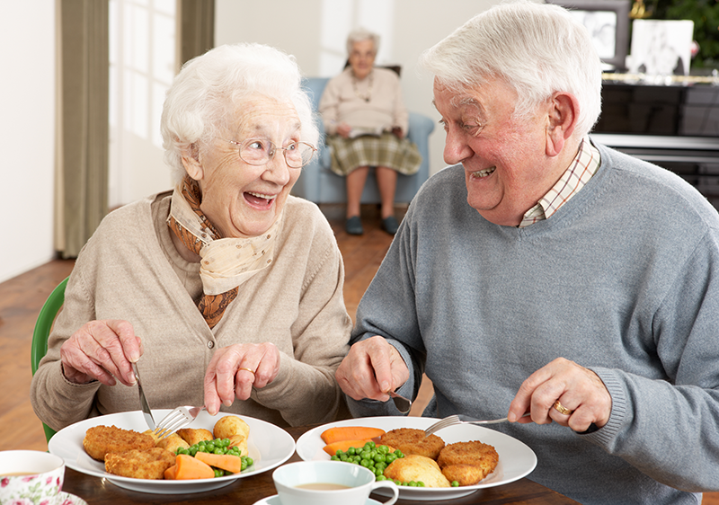 Smiling couple eating a meal