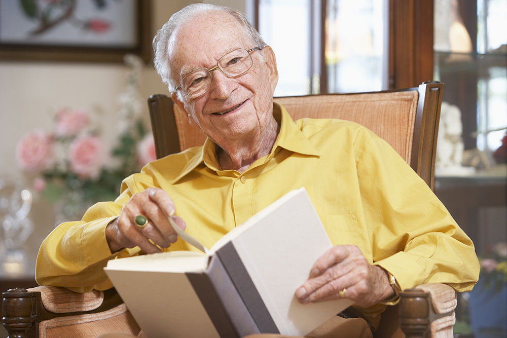 Elderly man reading a book