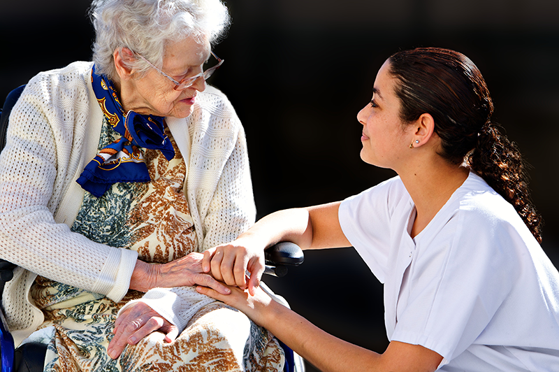 Elderly woman talking to nurse