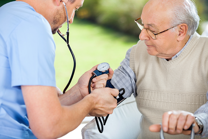 Nurse taking patient's blood pressure